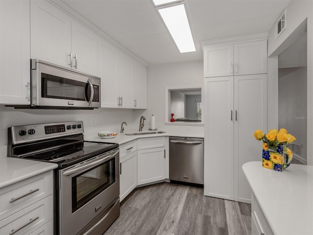 kitchen featuring white cabinets, sink, and stainless steel appliances