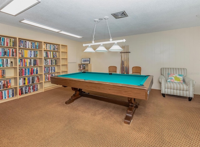 playroom with carpet, a textured ceiling, wood walls, and pool table