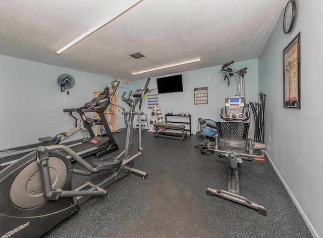 workout area featuring a textured ceiling