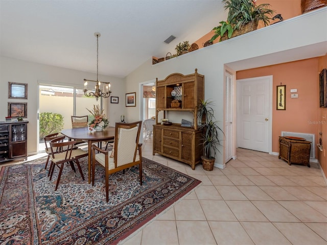 tiled dining area featuring high vaulted ceiling and an inviting chandelier