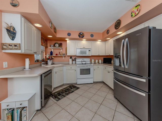 kitchen with white cabinetry, stainless steel appliances, and light tile patterned floors