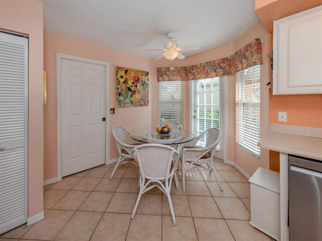 tiled dining space with a wealth of natural light and ceiling fan