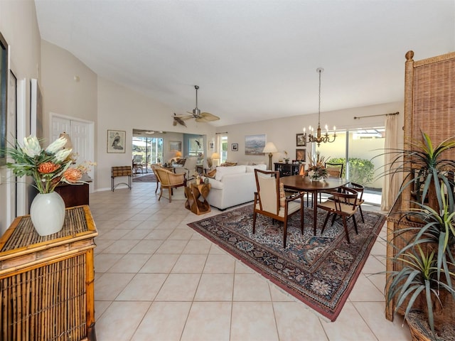 dining area featuring light tile patterned floors, ceiling fan with notable chandelier, and high vaulted ceiling