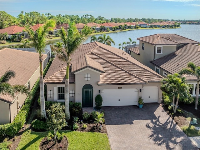 view of front of house with a garage and a water view