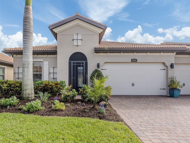 mediterranean / spanish-style house with a garage