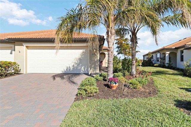 mediterranean / spanish house featuring a front lawn and a garage