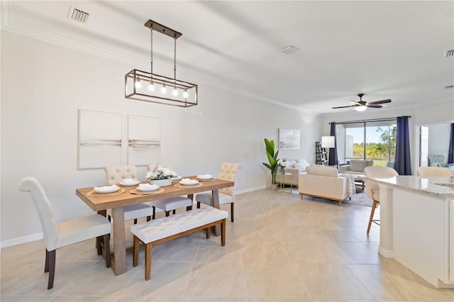 dining space with light tile patterned floors, ceiling fan, and ornamental molding