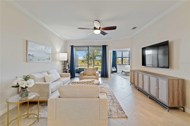 tiled living room featuring ceiling fan and crown molding