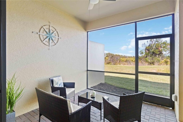 sunroom featuring ceiling fan