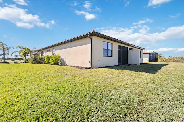 view of side of property with a lawn