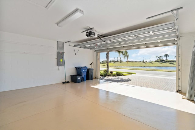 garage featuring electric panel, a water view, and a garage door opener