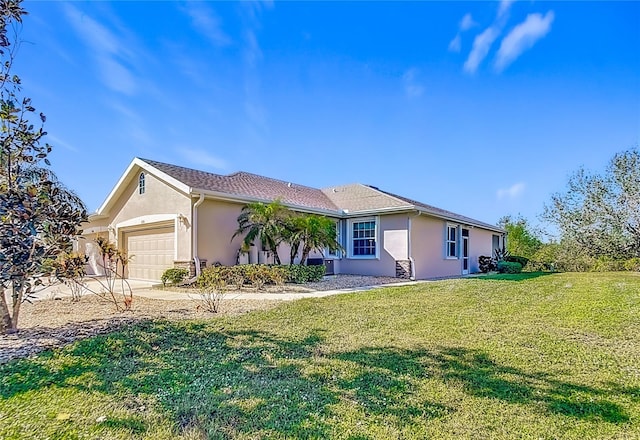 view of front of house featuring a garage and a front lawn