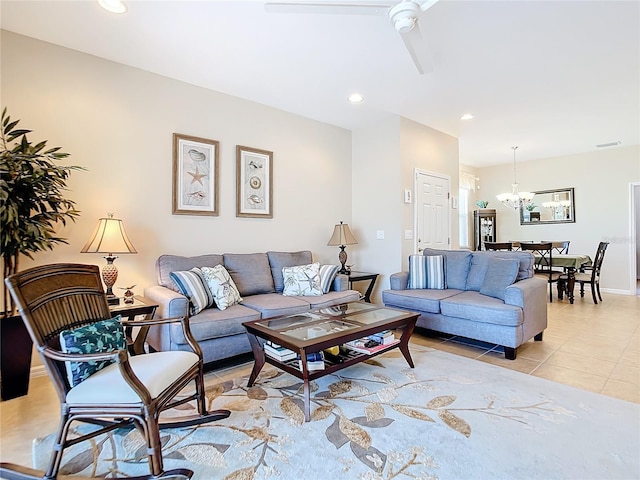 living room featuring ceiling fan with notable chandelier and light tile patterned floors