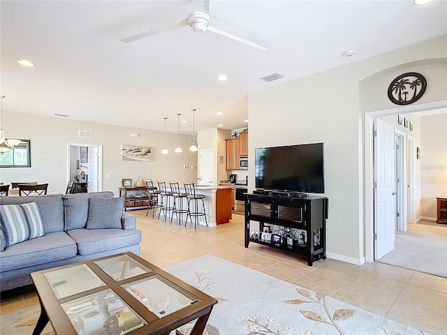 tiled living room featuring ceiling fan