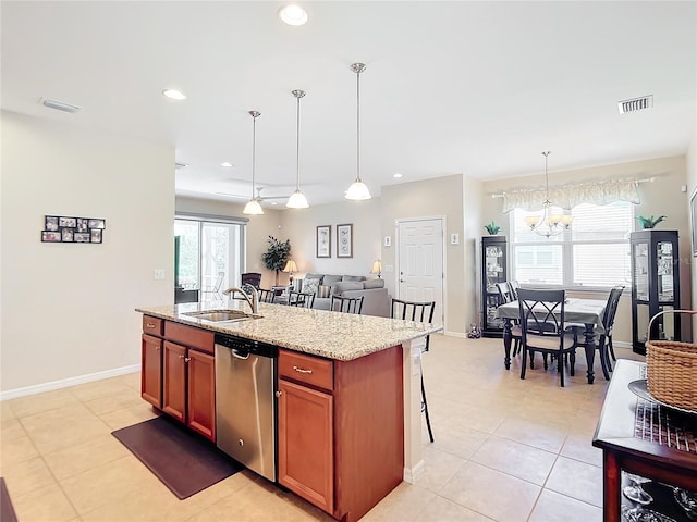 kitchen featuring light stone countertops, stainless steel dishwasher, decorative light fixtures, a center island with sink, and a chandelier