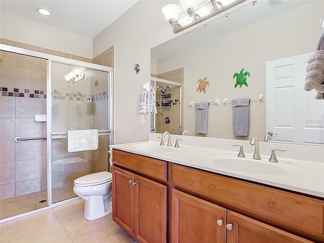 bathroom featuring tile patterned floors, vanity, an enclosed shower, and toilet