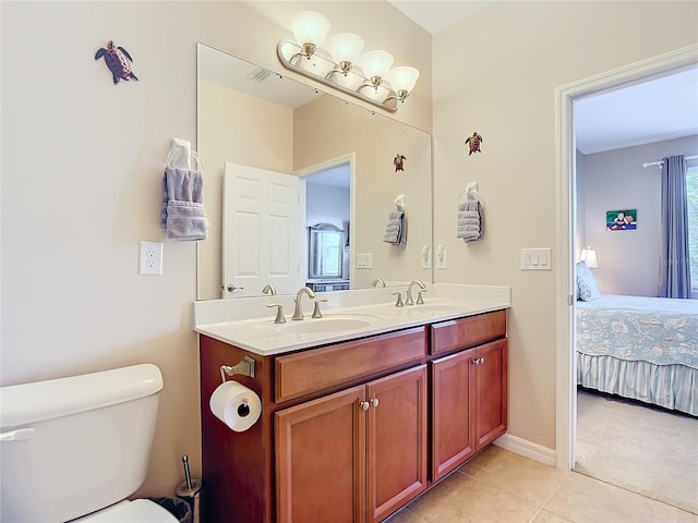 bathroom featuring tile patterned floors, vanity, and toilet