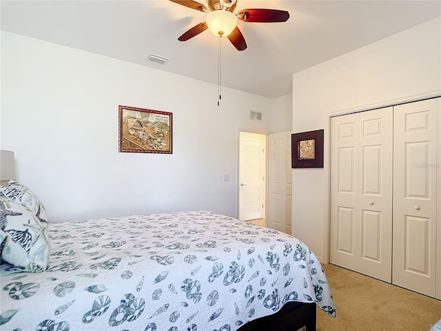 bedroom featuring ceiling fan, light carpet, and a closet