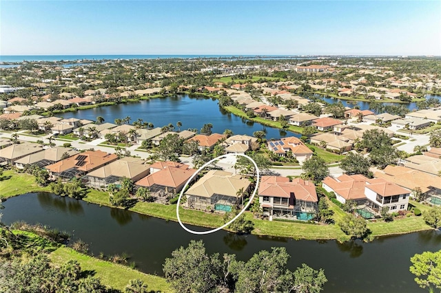 birds eye view of property with a residential view and a water view