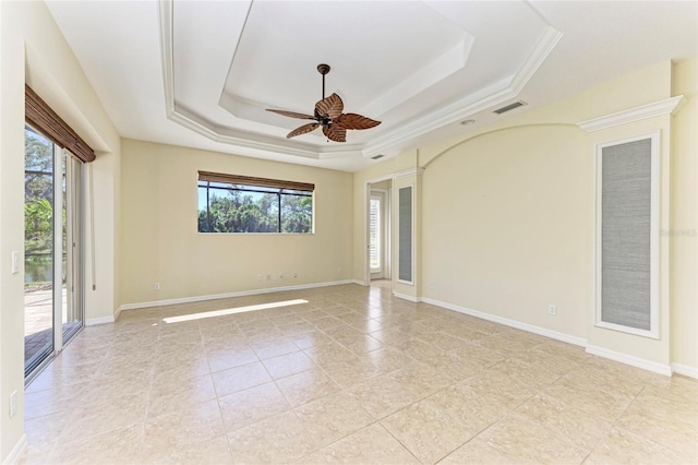 unfurnished room featuring light tile patterned floors, a raised ceiling, visible vents, ceiling fan, and baseboards