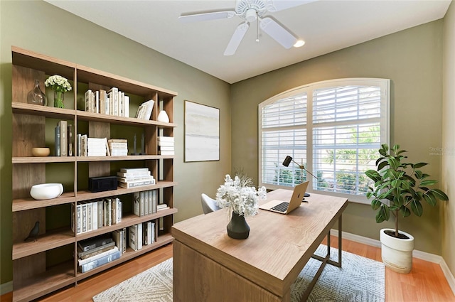 office with wood finished floors, a ceiling fan, and baseboards