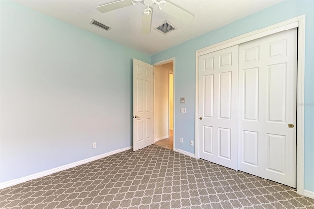 unfurnished bedroom featuring a closet, visible vents, baseboards, and carpet flooring