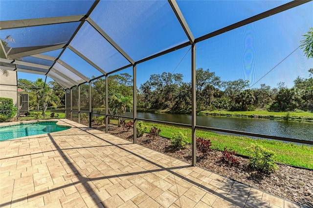 outdoor pool with a lanai, a water view, and a patio