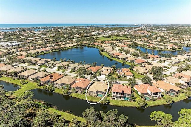 drone / aerial view featuring a water view and a residential view