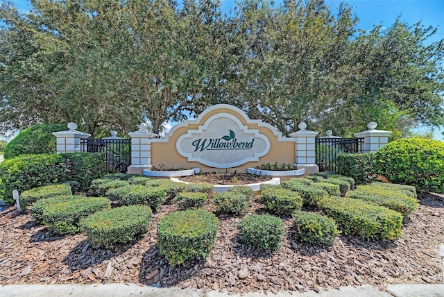 community / neighborhood sign with fence