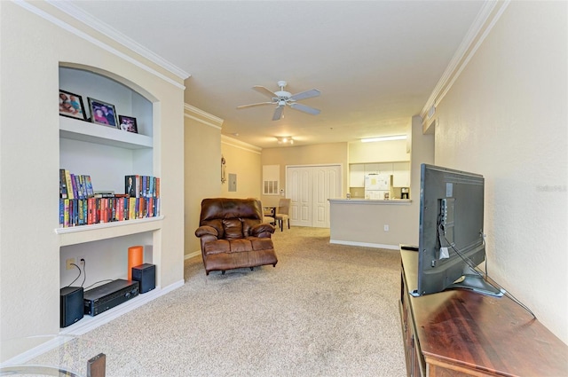 living area with carpet flooring, ceiling fan, built in features, and ornamental molding