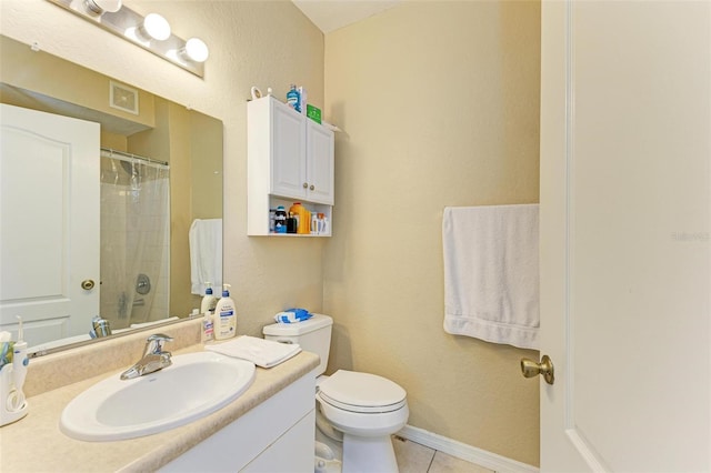 bathroom featuring tile patterned floors, vanity, and toilet