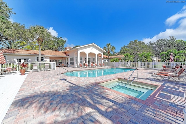 view of pool with a community hot tub and a patio area