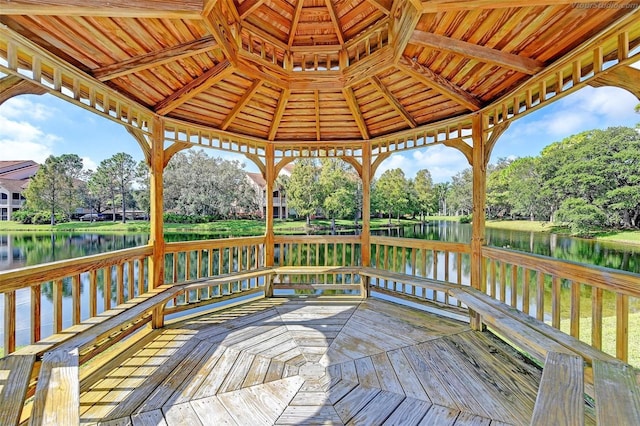 wooden terrace with a gazebo and a water view