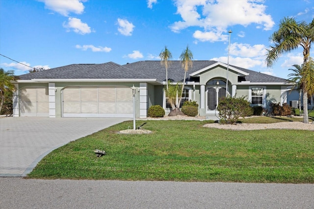 ranch-style home featuring a front yard and a garage