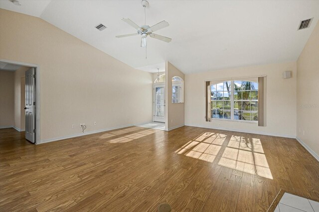 unfurnished living room featuring hardwood / wood-style floors, ceiling fan, and lofted ceiling