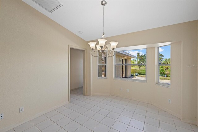 unfurnished dining area featuring lofted ceiling, light tile patterned floors, and a chandelier