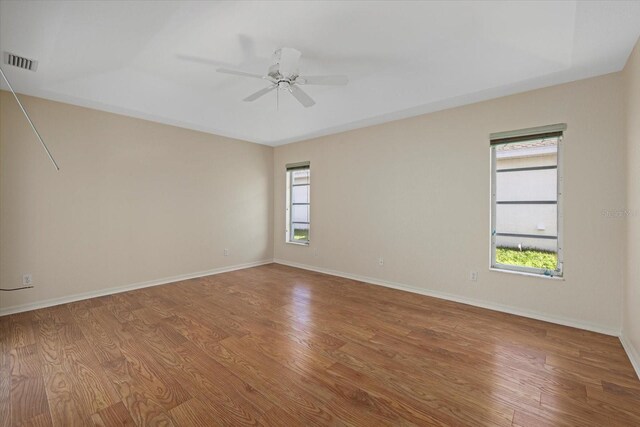 empty room with hardwood / wood-style flooring and ceiling fan