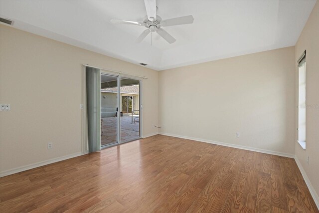 empty room with hardwood / wood-style floors and ceiling fan