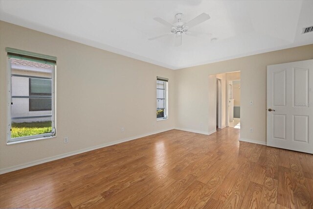 unfurnished room with light wood-type flooring and ceiling fan