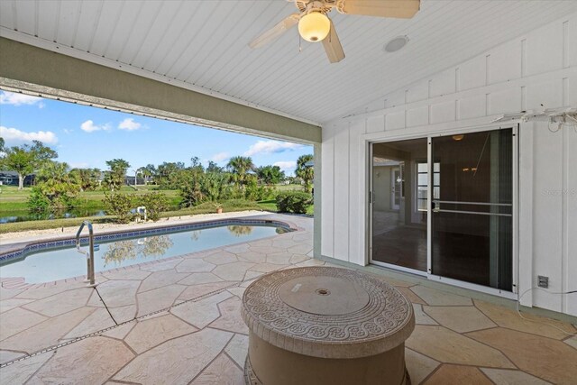 view of swimming pool featuring a patio and ceiling fan