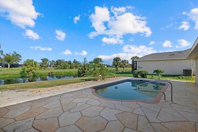 view of swimming pool with a water view, central AC unit, a patio area, and a lawn