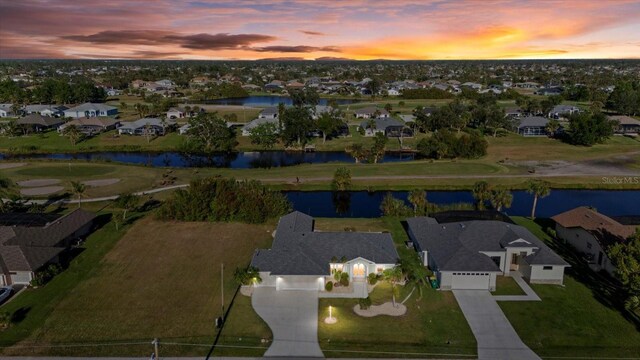 aerial view at dusk with a water view