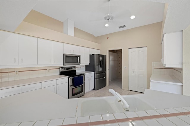 52 Fairway Rd, Rotonda West, FL 33947 - kitchen with appliances with stainless steel finishes, tasteful backsplash, white cabinets, and light countertops
