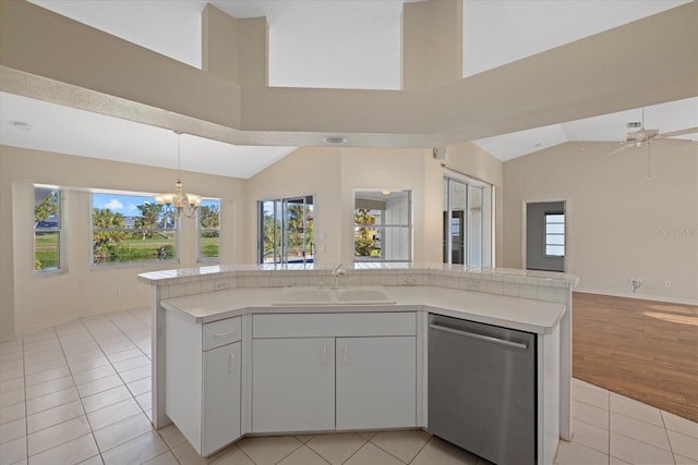 52 Fairway Rd, Rotonda West, FL 33947 - kitchen with stainless steel dishwasher, open floor plan, vaulted ceiling, light countertops, and plenty of natural light