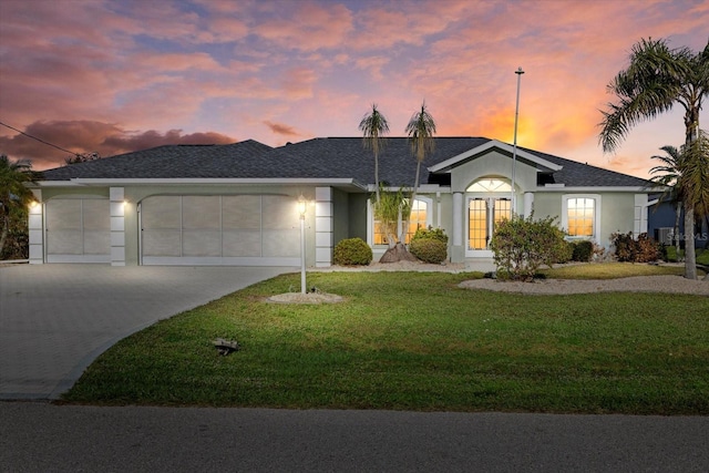 52 Fairway Rd, Rotonda West, FL 33947 - ranch-style house with a garage, driveway, a yard, stucco siding, and roof with shingles