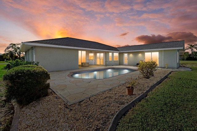 52 Fairway Rd, Rotonda West, FL 33947 - rear view of house with a patio area, an outdoor pool, and stucco siding