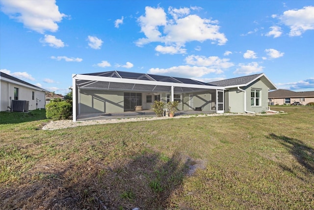 52 Fairway Rd, Rotonda West, FL 33947 - back of property featuring a lawn and glass enclosure