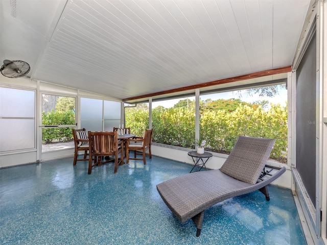 sunroom / solarium featuring a wealth of natural light and lofted ceiling