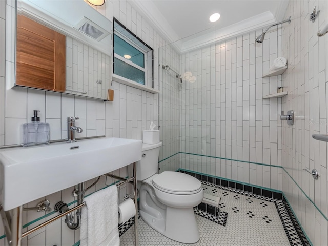 bathroom with tasteful backsplash, a tile shower, crown molding, tile walls, and toilet