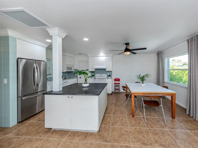 kitchen featuring ornate columns, ceiling fan, white cabinets, white appliances, and light tile patterned floors